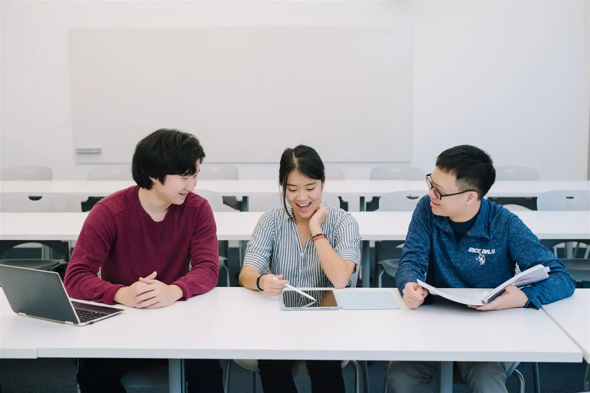 three students in a classroom