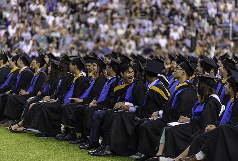 Students sitting in a row at commencement